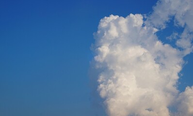 clear sky and puffy white clouds