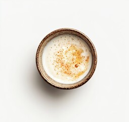 Creamy sauce in small bowl on white background