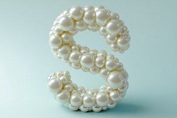 A large, intricate letter S made of small, round beads