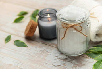 Magnesium flakes in a jar with burning candle for a relaxing spa treatment