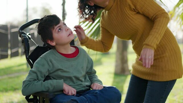 Disabled child interacting with mother outdoors