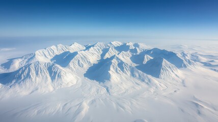 Aerial View of Snow Covered Mountain Range Under a Clear Blue Sky