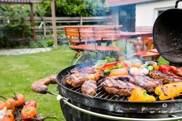 A family-friendly outdoor barbecue setup in a cozy backyard with a grill and picnic table.