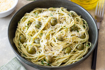 Pasta spaghetti with olives, herbs and cheese. Healthy food. Italian cuisine. Vegetarian food.