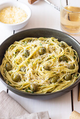 Pasta spaghetti with olives, herbs and cheese. Healthy food. Italian cuisine. Vegetarian food.