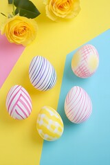 Fototapeta premium Colorful Easter Eggs and Yellow Roses on Pastel Background