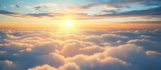 Fototapeta premium A breathtaking view of the sky, with fluffy white clouds and a radiant sun setting in the background. 