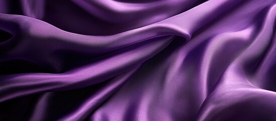 Obraz premium A high-resolution photograph of purple silk fabric, with the texture and sheen of the material in focus against a dark background. 