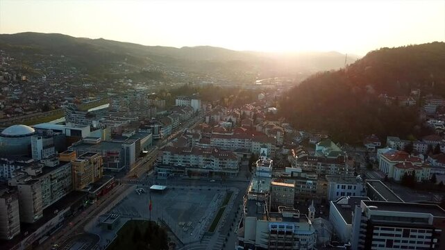 Aerial view from drone flying on the cityscape of Ramnicu Valcea at sunset