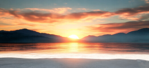 Fototapeta premium Beautiful sunset over calm water with silhouettes of hills in the background