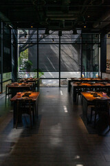 A cozy and atmospheric hot pot dining space invites guests to enjoy a warm, intimate meal in a dimly lit setting. Soft, ambient lighting casts a gentle glow over the wooden tables, where steaming
