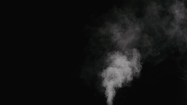 Slow motion water mist stream with wind effect over black background
