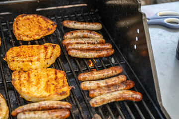 Barbecue grill bbq on propane gas grill steaks bratwurst sausages meat meal
