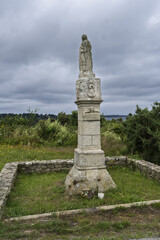 Fototapeta premium Catholic granite widows' cross where Icelandic fishermen's wives awaited the return of the sailors in Ploubazlanec, Brittany, France