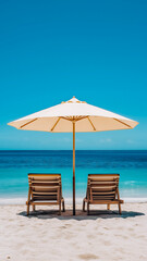 Relaxing beach chairs under a large umbrella on a sunny day by the ocean 