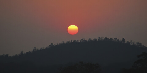 Obraz premium Sunset over mountain silhouette with vibrant sky