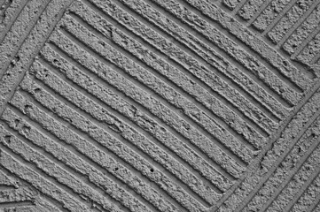 Fototapeta premium gray background, photo shows texture of decorative plaster on concrete wall close-up