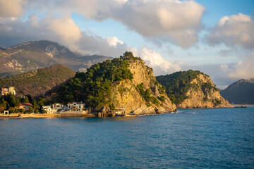 Naklejka premium Coast landscape with rocks, sea and vegetation near ancient fort in Petrovac, Montenegro in winter time.