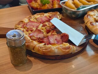 Hot pizza Margaritas on a gray concrete countertop. Cheese in a pizza crust. Tasty vegetable pizza