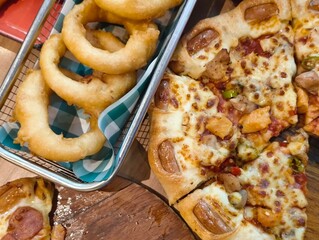 A variety of food such as pizza and fried onions Top view. Panorama with