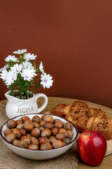 Croissants and hazelnuts on the table. Delicious healthy breakfast. Top view