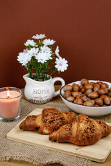 Croissants and hazelnuts on the table. Delicious healthy breakfast. Top view