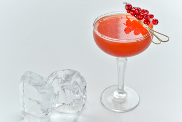 Bright cocktail with red currant on a white background