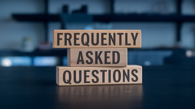 Wooden blocks displaying "FREQUENTLY ASKED QUESTIONS" in a modern office. Represents customer support, troubleshooting, business inquiries, online help, technical assistance, self-service, guidance