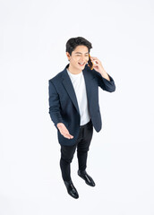 Full body image top view of a young Asian business man using phone and posing on a white background	