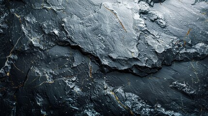 Dramatic close-up of a textured, dark slate surface with golden veins running throughout, creating a captivating abstract composition and a sense of depth