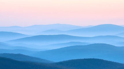 Fototapeta premium A misty mountain range with layers of hills fading into the distance, bathed in the soft light of dawn 