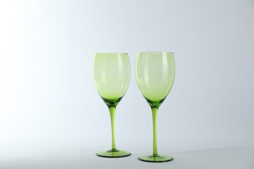 Two empty clean glasses on light background