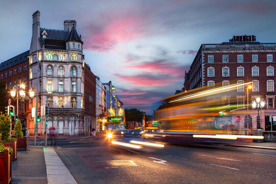 Elegant buildings, and blurred motion vehicles making light trails on the road in Dublin, Ireland