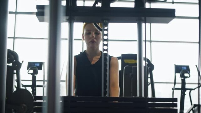 An athlete working out in the gym is lifting weights on a machine with blocks. The horizontal block thrust. Slow motion