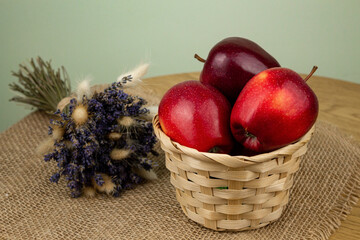 Red beautiful apples in a basket on the table. Red apples. Apple diet