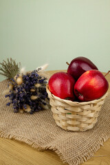 Red beautiful apples in a basket on the table. Red apples. Apple diet