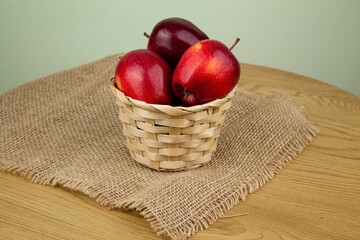 Red beautiful apples in a basket on the table. Red apples. Apple diet