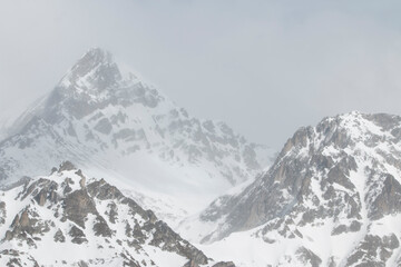 Layers of Silence: Snowy Peaks in the Mist