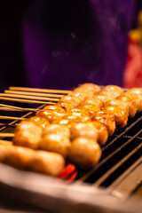 A person is cooking meat on a grill