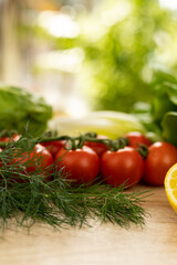 Red tomatoes, lettuce leaves on the table closeup. Vegetables for salad on table