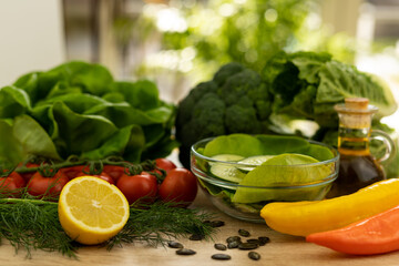 Red tomatoes, lettuce leaves on the table closeup. Vegetables for salad on table