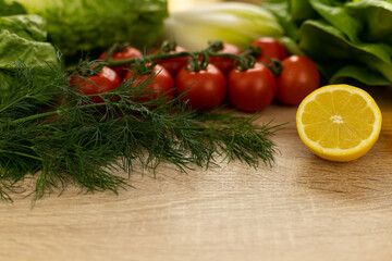 Red tomatoes, lettuce leaves on the table closeup. Vegetables for salad on table