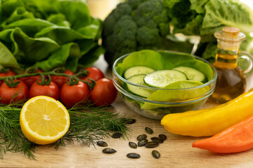 Red tomatoes, lettuce leaves on the table closeup. Vegetables for salad on table