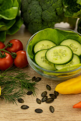 Red tomatoes, lettuce leaves on the table closeup. Vegetables for salad on table