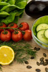 Red tomatoes, lettuce leaves on the table closeup. Vegetables for salad on table