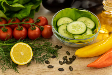 Red tomatoes, lettuce leaves on the table closeup. Vegetables for salad on table