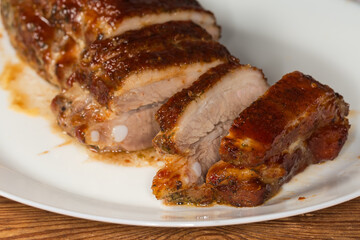 Partially sliced baked pork ribs, close-up in selective focus
