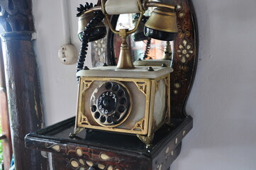 Antique vintage telephone stands on mother-of-pearl inlaid stand