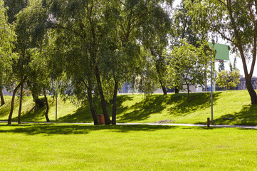 Walkway surrounded by trees and lawns in Kyiv, Europe. Recreation place in the city park