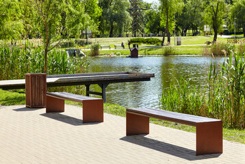 Rest area with wooden Observation deck on the river embankment in Kyiv, Europe. Place to rest in the city park